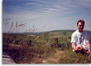 The author on Milk Hill, with Wansdyke crossing Tan Hill in the distance, 1994